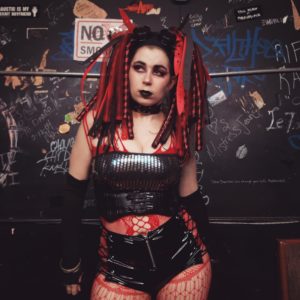 Image of Sitri in red and black back stage at Ground Zero. 